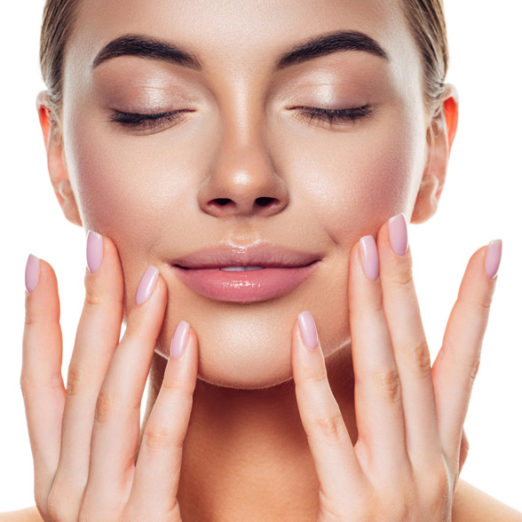 woman-with-glowing-skin-gently-touching-her-cheeks