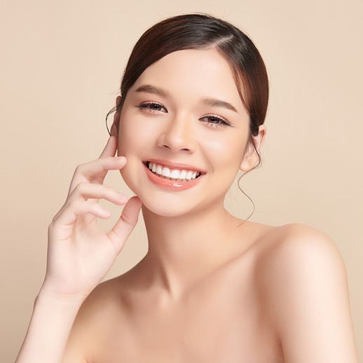 woman-with-radiant-skin-smiling-brightly-and-touching-her-cheek