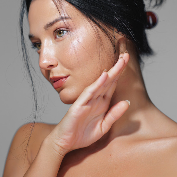 woman-with-smooth-skin-looking-to-the-side-and-lifting-her-hand-near-her-face