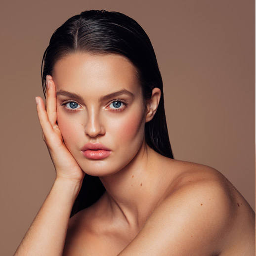 woman-with-smooth-skin-resting-her-face-on-her-hand