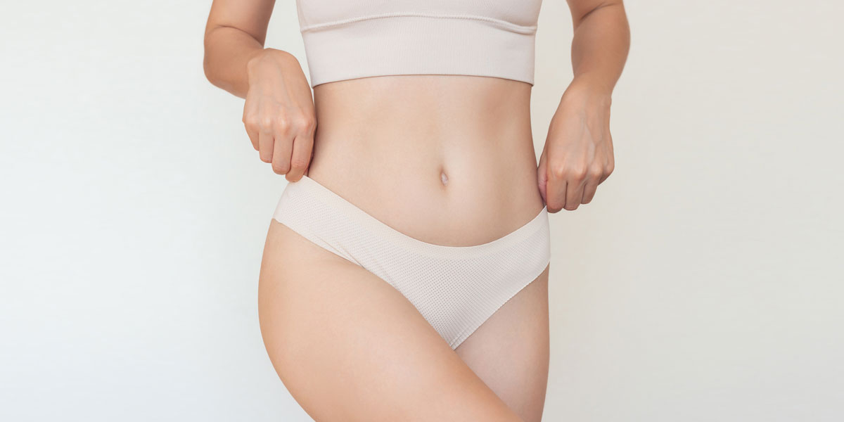 Woman adjusting waistband of underwear around hips
