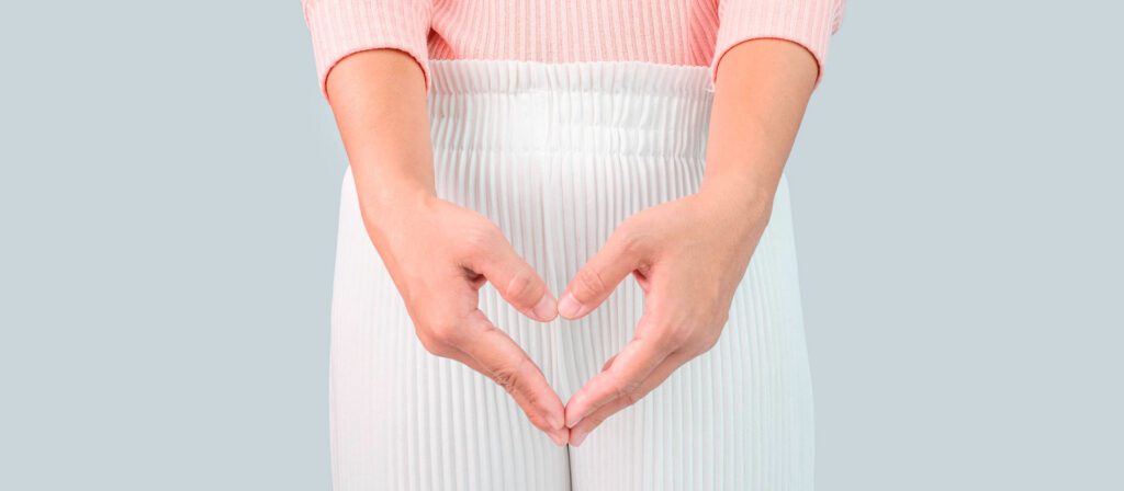 woman-forming-a-heart-shape-with-her-hands-over-her-lower-abdomen