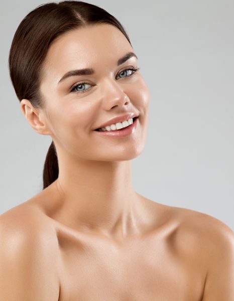 Woman smiling with radiant smooth skin and natural glow